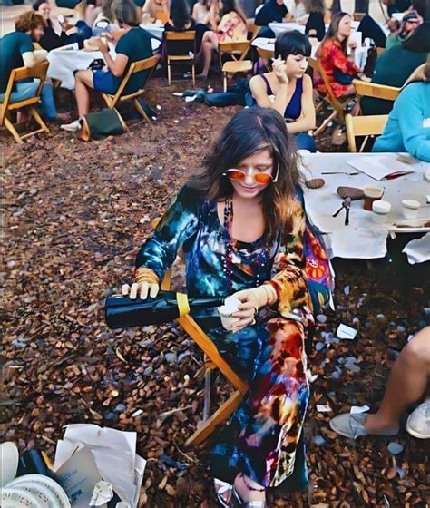 janis joplin pouring herself a drink before going on stage at woodstock 1969 r