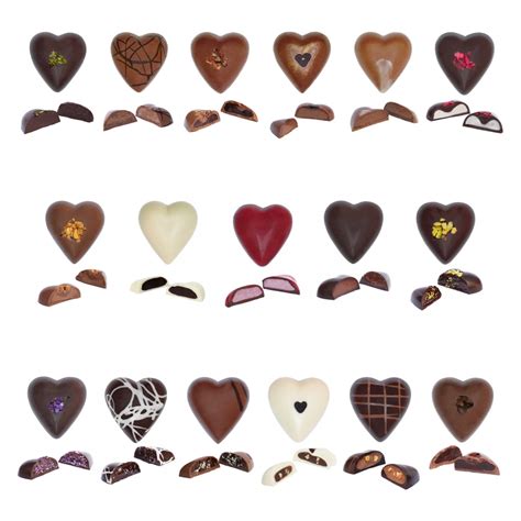 The rectangular box, decorated with a heart and geometric patterns in reds and pinks, holds three rows of chocolate hearts. Luxurious heart-shaped chocolate box, created for lovers ...