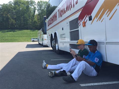 This Photo Of Two Little Leaguers Glued To Their Phones Is Not What You