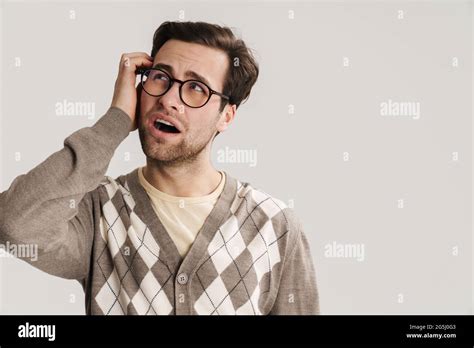 Brooding Handsome Guy In Eyeglasses Looking Upward Isolated Over White