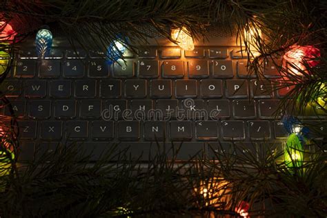 Laptop Keyboard Surrounded By Lights Of Christmas Garland Christmas