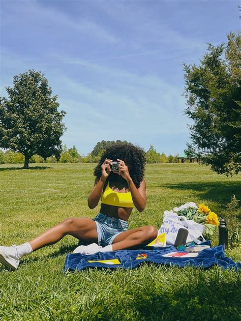 Black Woman With Curly Hair Outdoors At Picnic With Yellow Bralette And