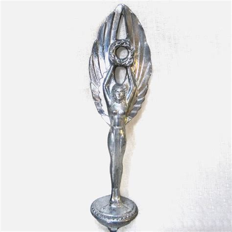Tall Art Deco Winged Nymph With A Wreath Held High Overhead This Hood Ornament Or Mascot Is 8 1