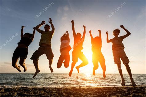 People Jumping At Beach — Stock Photo © William87 44584063