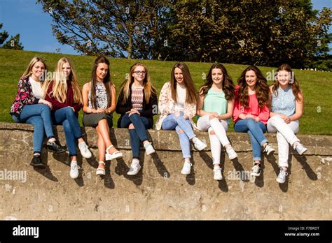 Eight Smiling Teenage Girls Having Fun Sitting Crossed Legged On The