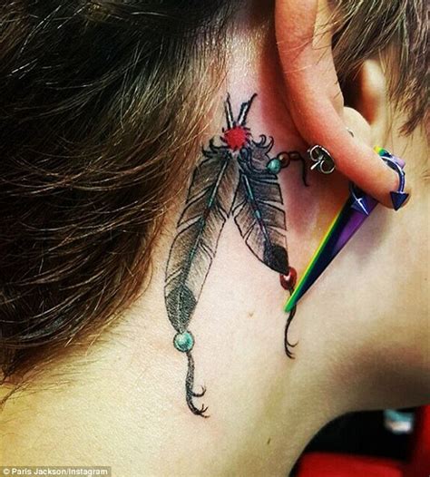 Paris Jacksons Latest Tattoo A Double Feather Inked Behind Her Ear