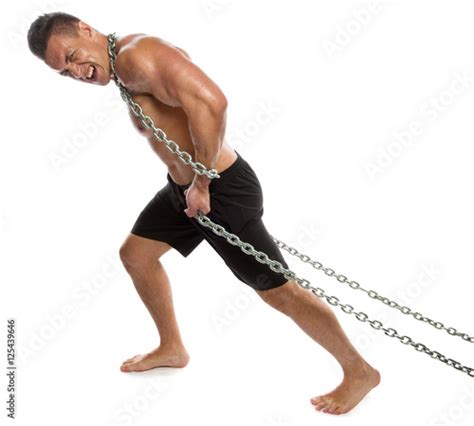 Athletic Man Pulling A Cargo Of Metal Chains Stock Photo And Royalty