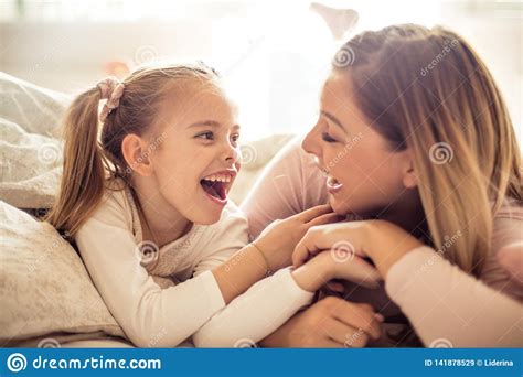 Mother And Daughter Having Conversation In Bed Stock Image Image Of