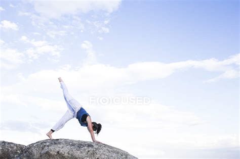 Woman Doing Yoga Exercise — Balance Rock Stock Photo 164841794