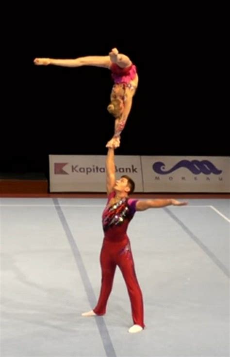 Two People Doing Acrobatic Tricks On The Floor