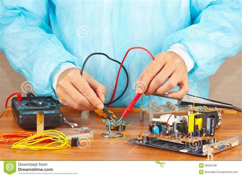 Master Checks Board Of Electronic Device With A Multimeter Stock Image