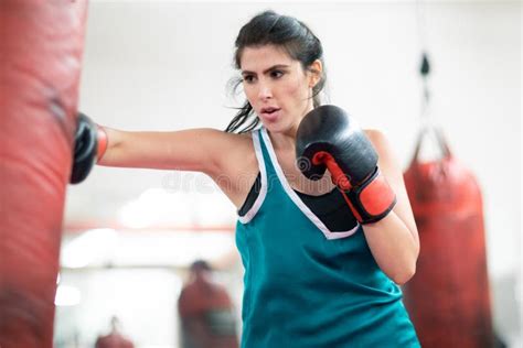 A Young Female Boxer Punching A Bag In The Gym Stock Image Image Of