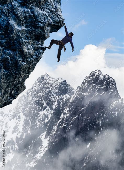 Adult Adventurous Man Rock Climbing A Steep Rocky Cliff Extreme