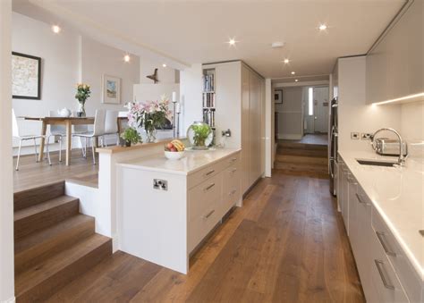 Enigma Design » Contemporary Galley Kitchen Yellow themed open kitchen with l shaped working counter increases productivity and space utilization.