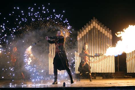 Fire Juggler Performing At Night On Stage Juggling With Torches Kyiv