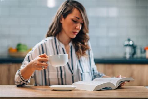 premium photo woman drinking coffee and reading book