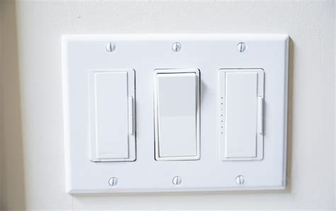 Premium Photo A White Light Switch With One Of The Switches On The