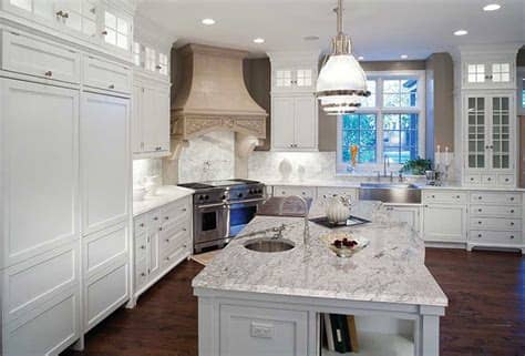 Open concept transitional white kitchen features luxor custom made white shaker cabinets, massive island with comfortable seating, countertops the large granite island creates perfect space for food preparation and seating/eating area. Top 25 Best White Granite Colors for Kitchen Countertops