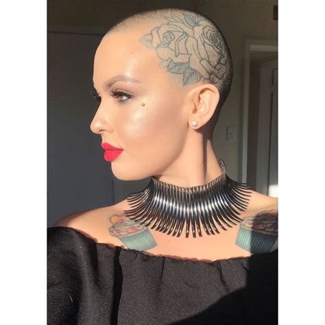 A Woman With Tattoos On Her Neck Wearing A Black Top