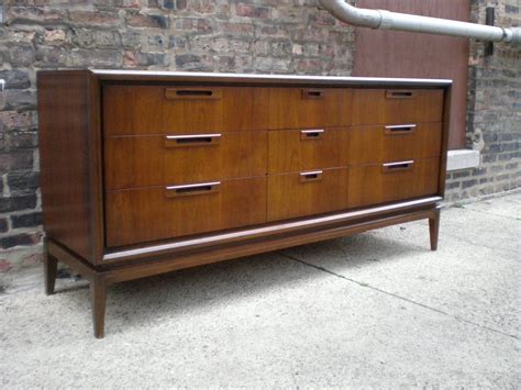 Many feature architectural details on the faces or handles—diamond shapes were especially popular. Mid Century Chicago: Danish Modern 9 Drawer Lowboy Dresser