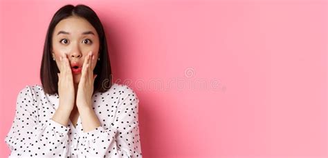 Close Up Of Surprised And Amazed Asian Woman Staring At Camera Gasping Impressed Holding Hands