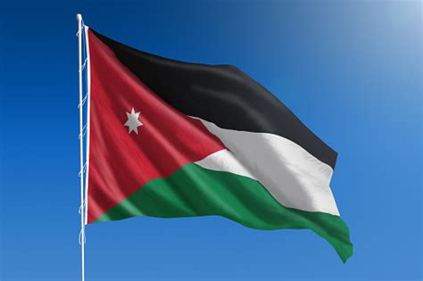National Flag Of Jordan On Clear Blue Sky Stock Photo Download Image