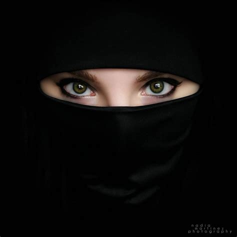 Portrait Of Beautiful Arabian Girl Hiding Her Face Behind Red Niqab A14