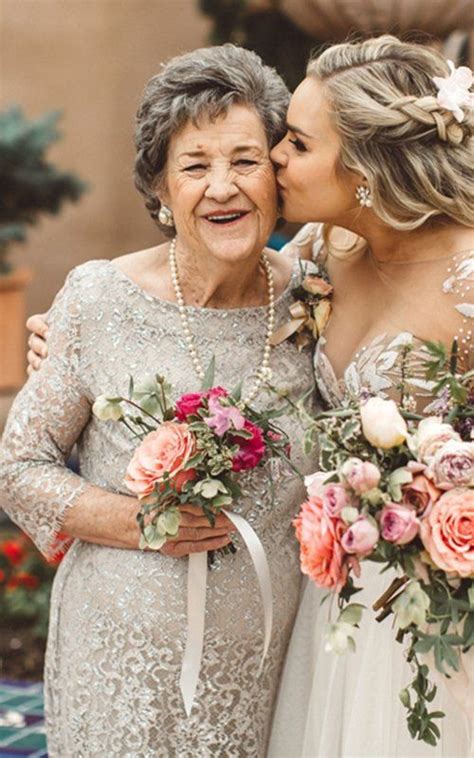Two Older Women Are Kissing Each Other And Holding Bouquets In Front Of