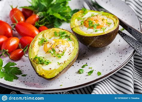 Avocado Baked With Egg And Fresh Salad Vegetarian Dish Stock Image