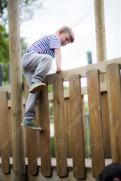 Boy Climbing Over Wooden Fence Stock Image F0128153 Science