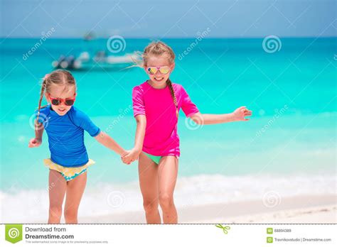 Kids Having Fun At Tropical Beach During Summer Vacation Playing
