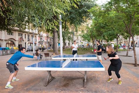 People Playing Ping Pong In A Plaza In Barceloneta