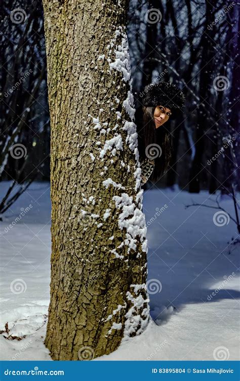 Girl Hiding Behind The Tree On A Snowy Evening Stock Photo Image Of