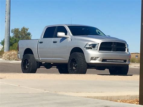 A Silver Truck Is Parked On The Street