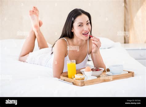 Pretty Brunette Eating Her Breakfast On Bed Stock Photo Alamy