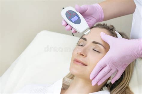 Cosmetologist Makes An Ultrasonic Cleaning Of The Face Stock Photo