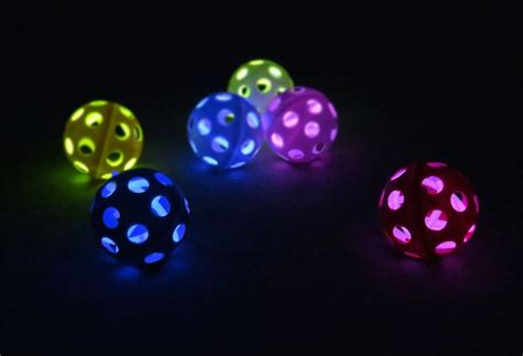 Four Glowing Dices Are Shown In The Dark