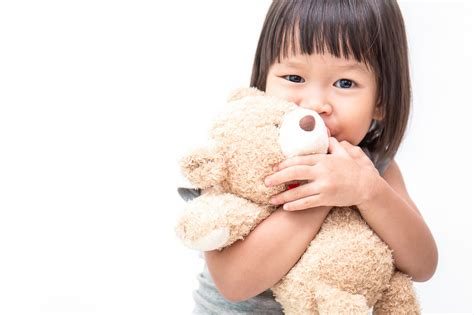 Asian Cute Little Child Girl Hugging Teddy Bear Isolated On White