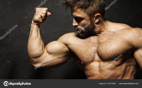 Bodybuilder Flexing Biceps Stock Photo By ©magann 153770622