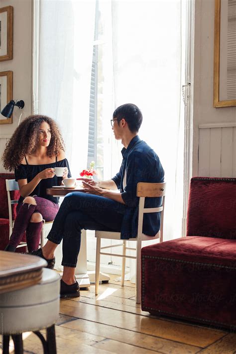 Trendy Couple Having Breakfast In A Coffee Shop By Stocksy