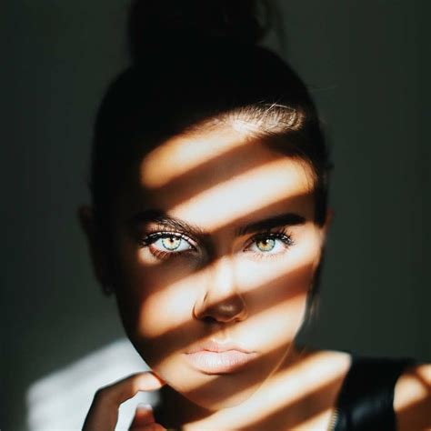beautiful woman in the shadow with the sunlight beaming through the window s b… portrait