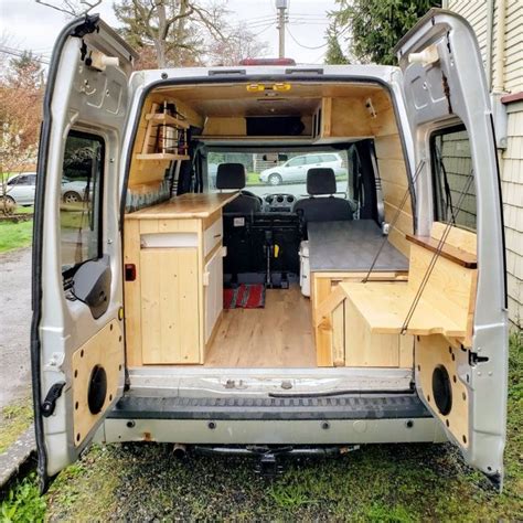 The Interior Of A Van With Wood Paneling And Storage Compartments On