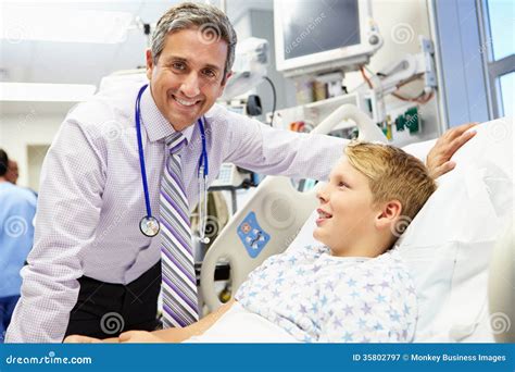 Boy Talking To Male Consultant In Emergency Room Stock Image Image Of