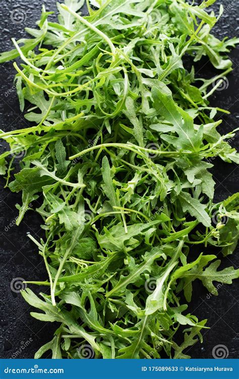 Fresh Leaves Of Young Arugula On A Black Background Stock Image
