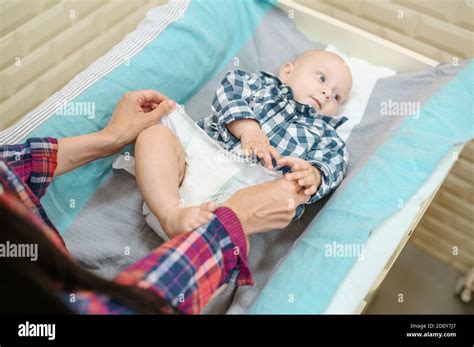 Mother Changing Diapers For Her Little Son Stock Photo Alamy