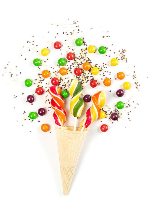 Lollipops In Waffle Cone And Multicolored Chocolate Candies On White