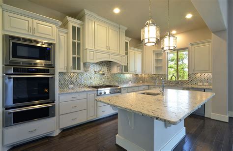 Shop range hoods to improve your kitchen ventilation. Model home kitchen cabinets in Bone white -Burrows Cabinets