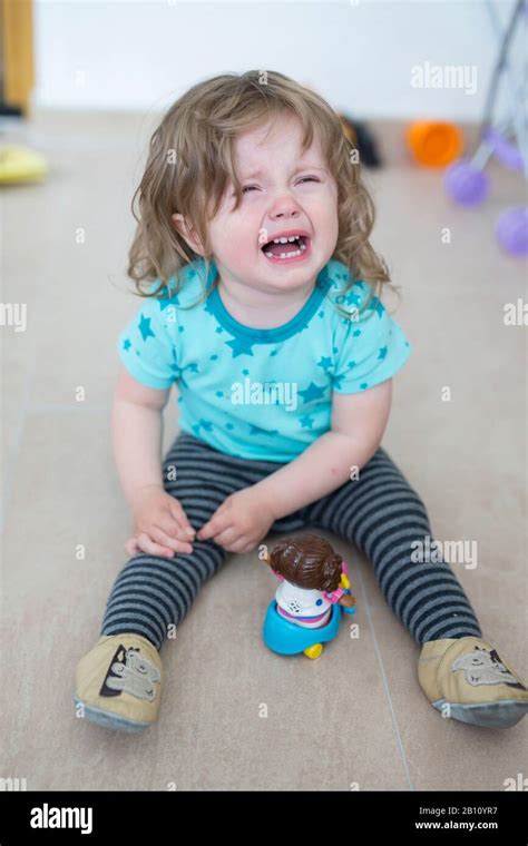 Little Girl Sits Crying On The Floor Hi Res Stock Photography And