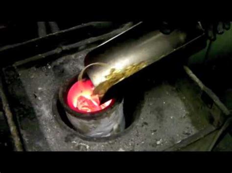 Metal is loaded into the smelter. Melting old Scrap Gold Jewellery - YouTube