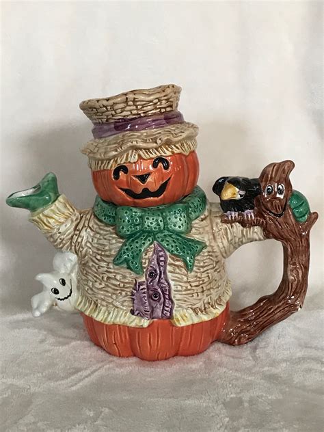 A Ceramic Pumpkin Sitting On Top Of A Basket